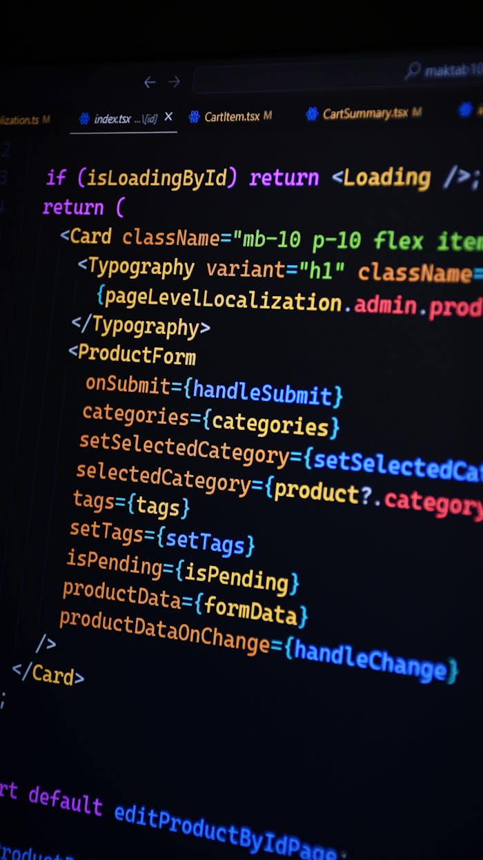 our-experience Close-up of JSX code on a monitor, showcasing colorful syntax used in ReactJS development.